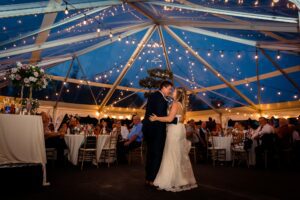 bride and groom first dance during summer backyard wedding reception in Monkland, ON