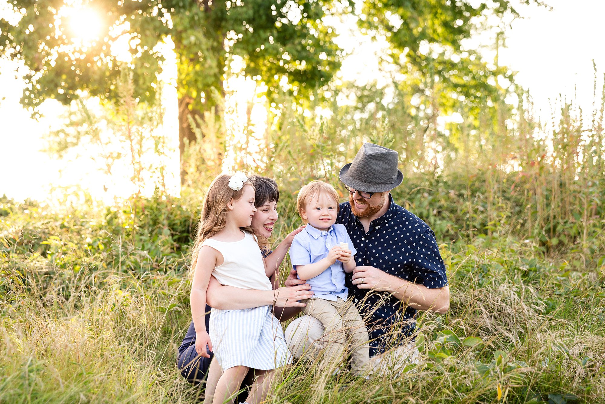 candid photo of family in long grass in Ottawa, Ontario
