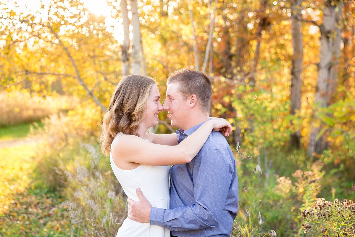 Ottawa Engagement Portraits - Couple embracing in rural fall setting