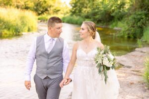 bride and groom wedding photos at a farm river near Ottawa, ON