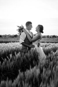 sunset wedding portrait in a wheat field during farm wedding in North Stormont, ON