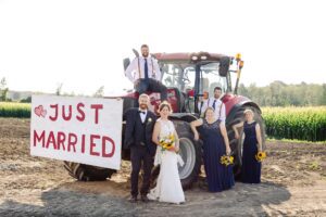 wedding party portraits with tractor - farm wedding in Alexandria, ON