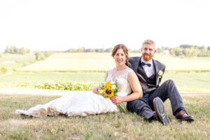 bride and groom in front of farm fields
