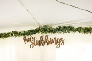 outdoor wedding tent with navy and greenery