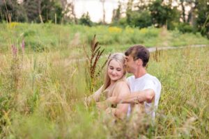 couple in long grass during golden hour