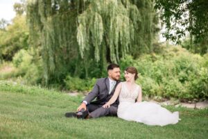 Bride and groom portraits sitting on grass in Ottawa, ON