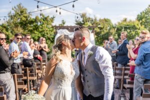 bride and groom recessional kiss