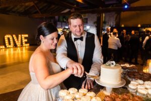 bride and groom cut the cake for New Year's Eve wedding at Code's Mill in Perth, ON
