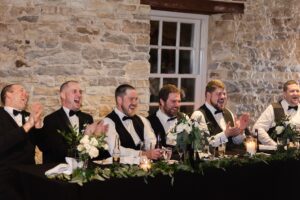 groomsmen laughing during wedding reception