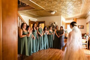 first look with bridesmaids in old farmhouse