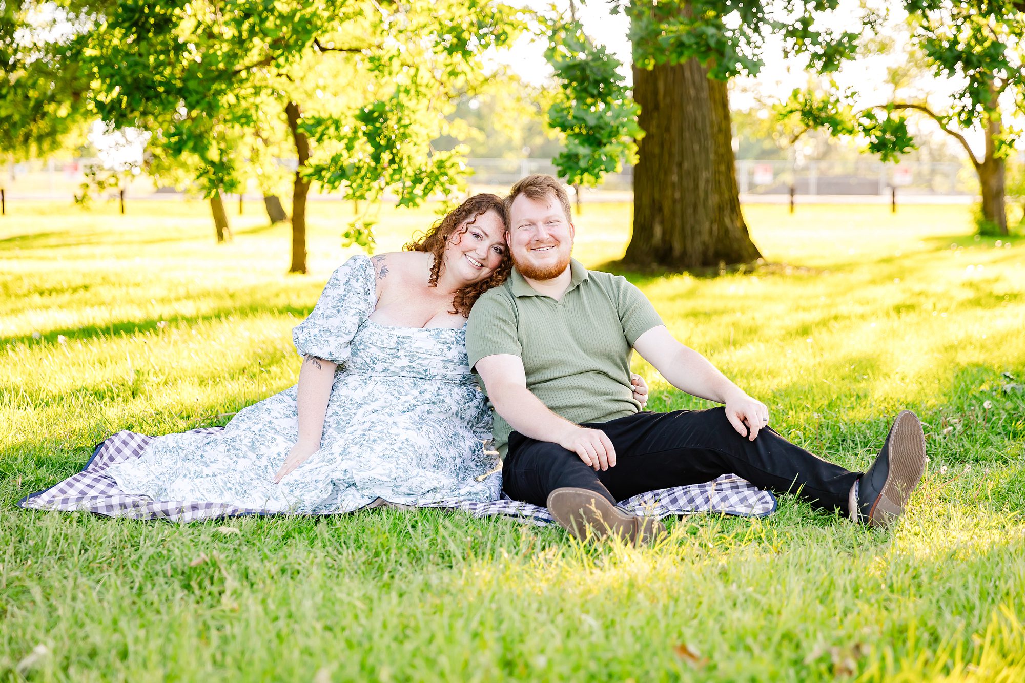 Couple Sitting on Lawn for Engagement Pictures in Ottawa, ON