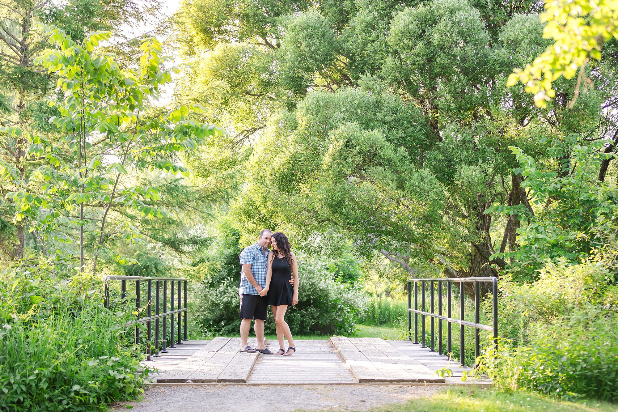 couple on bridge for their engagement portraits in Ottawa