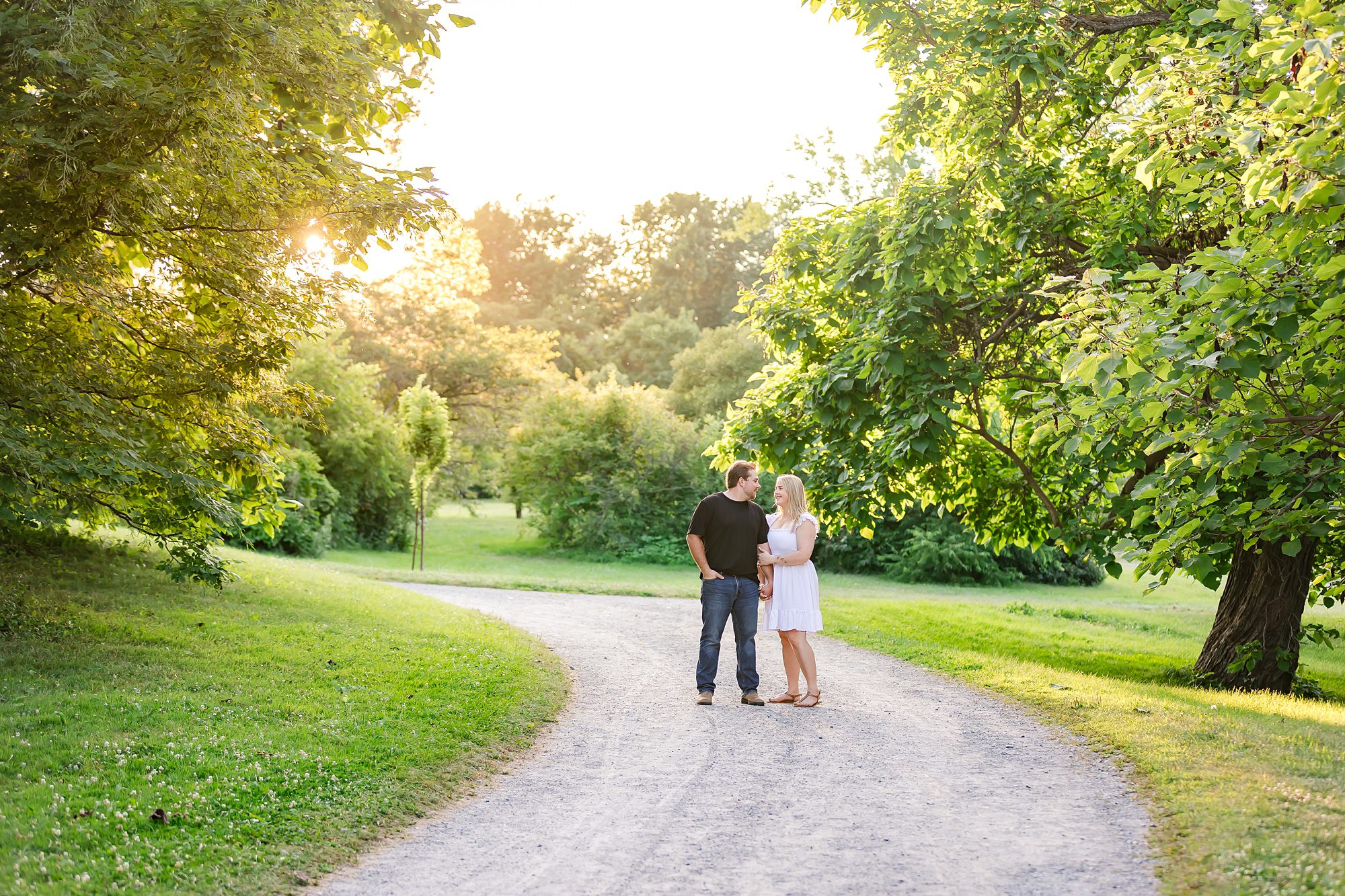 couple standing together on pathway during golden hour in Ottawa, ON